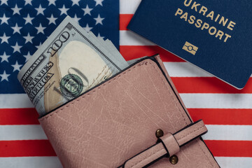 Leather wallet with hundred dollar bills, passport on the background of the USA flag. Travel or...