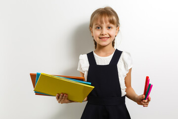 little blond school girl with backpack bag portrait isolated on white background