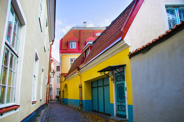 Fototapeta na wymiar Buildings and architecture exterior view in old town of Tallinn, colorful old style houses and street situation. Tallinn, Estonia.