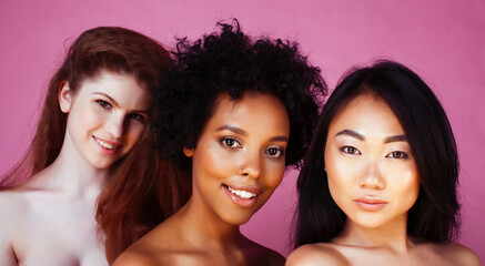 different nation girls with diversuty in skin, hair. Asian, scandinavian, african american cheerful emotional posing on pink background, woman day celebration, lifestyle people concept