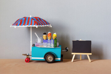 Mobile trolley ice cream lemonade shop. Ice cream in waffle cones, cold drinks. Big blue red...