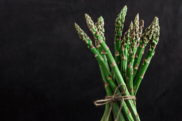 Asparagus. Fresh green asparagus on black  background.