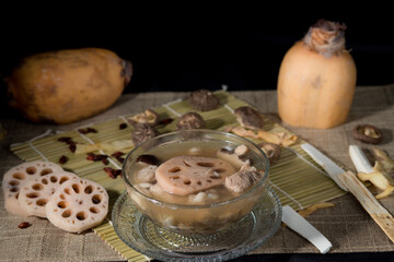Lotus root soup with beans in a bowl and Chinese herbs, shiitake mushroom, lotus root