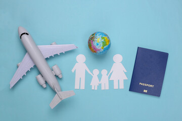 Travel or family immigration. Paper family together, plane, globe and passport on a blue background.