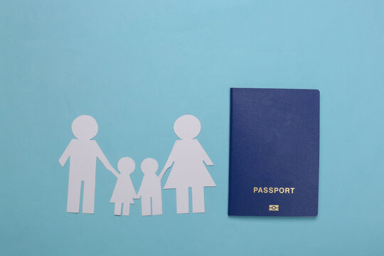 Travel or family immigration. Paper family together and passport on a blue background.