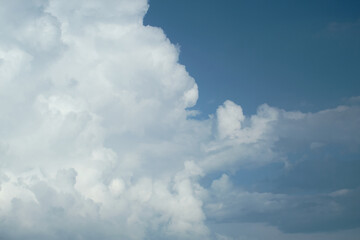 A large white cloud against a blue sky. Copy space