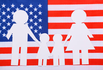 Paper cut family chain on background of USA flag. Patriotism theme