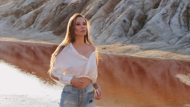 Beautiful woman posing on other-worldly hilly landscape