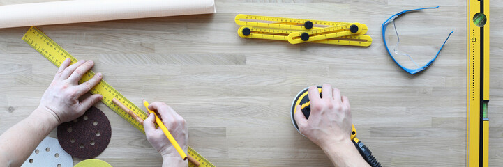 Top view of workers preparing for work day. Professional tools on wooden table. Ruler project plan...