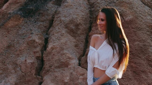 Beautiful woman posing on other-worldly hilly landscape