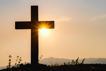 Silhouette cross on mountain at sunset background.Crucifixion Of Jesus Christ
