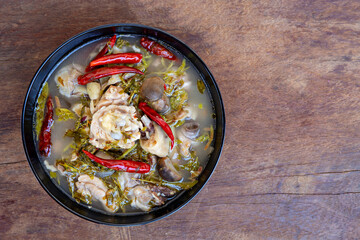 Boiled chicken cup on wooden table, northeast style food,Thai food on black cup.