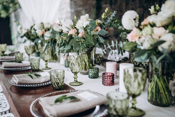 Flower decoration of wedding tables.
Banquet table setting and decoration. Cutlery on the table. 