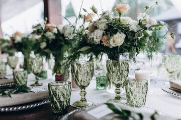 Flower decoration of wedding tables.
Banquet table setting and decoration. Cutlery on the table. 