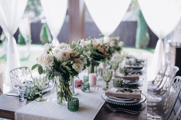 Flower decoration of wedding tables.
Banquet table setting and decoration. Cutlery on the table. 