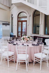 Flower decoration of wedding tables.
Banquet table setting and decoration. Cutlery on the table. 