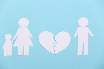 Broken family, divorce. Split paper family, broken heart on blue background