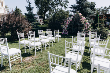 Wedding flower decorations from roses. Decoration for the ceremony. A place for guests.
