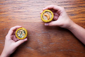 Nutrition concept - hand holds a healthy  quiche over wooden background. Healthy food, Diet, Detox, Clean Eating or Vegetarian concept