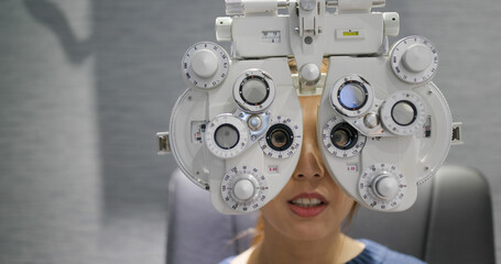 Woman check her eye at clinic