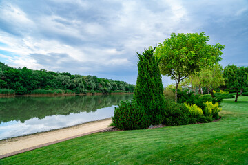 landscape. summer green meadow by river in Sunny weather.