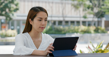 Woman look at digital tablet computer at outdoor