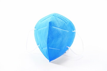 The blue medical N95 mask stands alone against a white background
