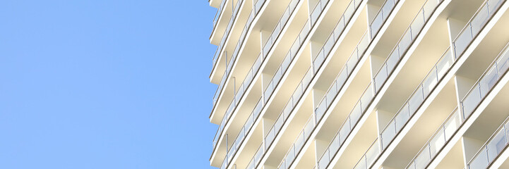 Focus on skyscraper on clear blue sky background. Exterior of house with apartments and many floors. Facade of construction for metropolis. Contemporary architecture