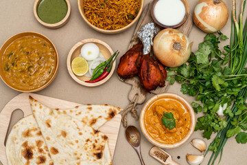 Various indian food menus, biryani rice, butter chicken, tandoori, bean curry and naan bread