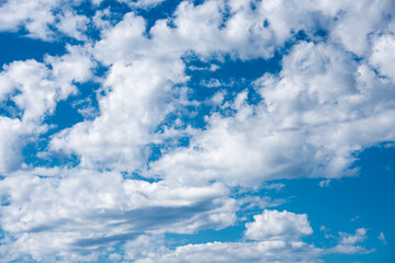 Obraz na płótnie Canvas White heap clouds in the blue sky. Cloudscape over horizon. Heaven
