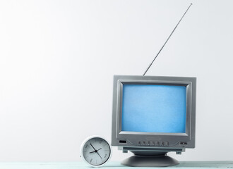 Antenna old-fashioned retro tv receiver and clock on white wall background
