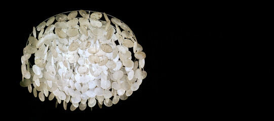 luminous chandelier hanging on a black background