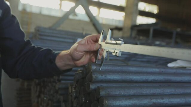 Measuring the diameter with a vernier caliper. Worker measures the diameter,