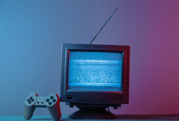 Antenna old-fashioned  tv receiver with gamepad in pink blue gradient neon light. Retro media,...