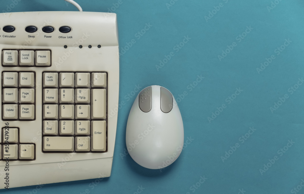 Poster old-fashioned retro keyboard and pc mouse on blue background. retro computer. top view