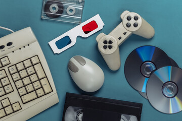 Retro entertainment. Old-fashioned keyboard, pc mouse, compact discs, gamepad, anaglyph glasses,...