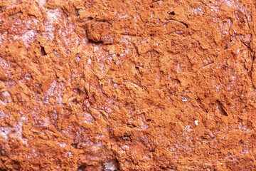 Orange brick wall that is eroded