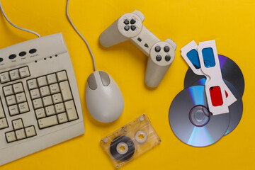 Retro entertainment. Old-fashioned keyboard, pc mouse, compact discs, gamepad, anaglyph glasses,...