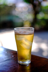 Cold beer in glass on wood table
