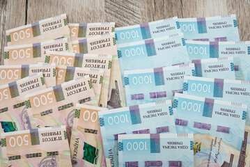 a lot of banknotes in denominations of 1000 and 500 hryvnia. Money background. Financial concept. Ukrainian money on a wooden background. Close-up.