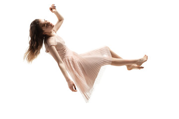 Mid-air beauty cought in moment. Full length shot of attractive young woman hovering in air and...