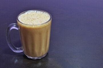 Teh tarik or pulled tea is a famous sweet milk tea in Malaysia. Bubble is floating on the surface of teh tarik.