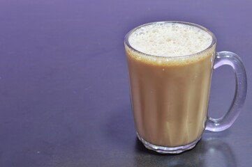 Teh tarik or pulled tea is a famous sweet milk tea in Malaysia. Bubble is floating on the surface of teh tarik.