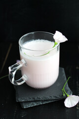 Vegan pink Moon milk on black background. a dreamy sleep tonic.