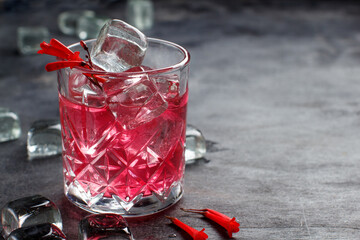 Cosmopolitan cocktail in a glass decorated with pink flowers