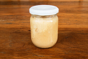 Nutrition concept - Green Banana Biomass in glass jar, good source of fiber, vitamins and minerals, and contains a starch that may help control blood sugar, manage weight and lower blood cholesterol.