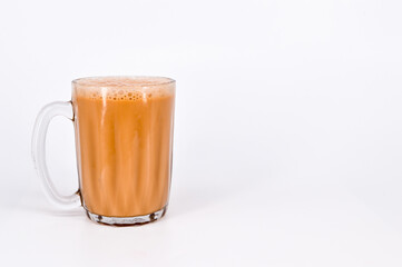Teh tarik or pulled tea is a famous sweet milk tea in Malaysia. Bubble is floating on the surface of teh tarik.