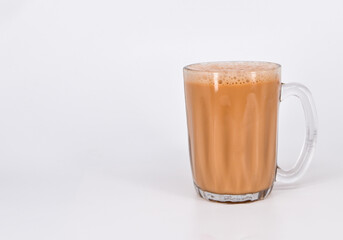 Teh tarik or pulled tea is a famous sweet milk tea in Malaysia. Bubble is floating on the surface of teh tarik.