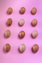 Eggs in kitchen top view pink background - natural food pattern