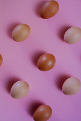 Eggs in kitchen top view pink background - natural food pattern